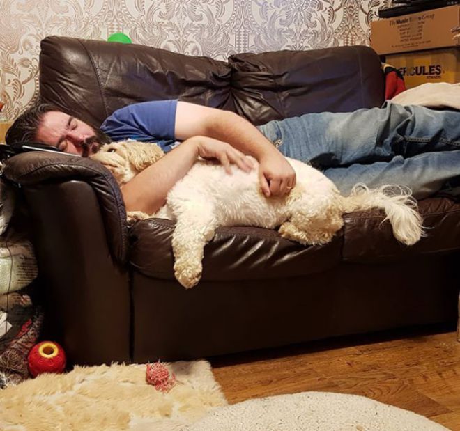 Мужчина спит в обнимку с собакой