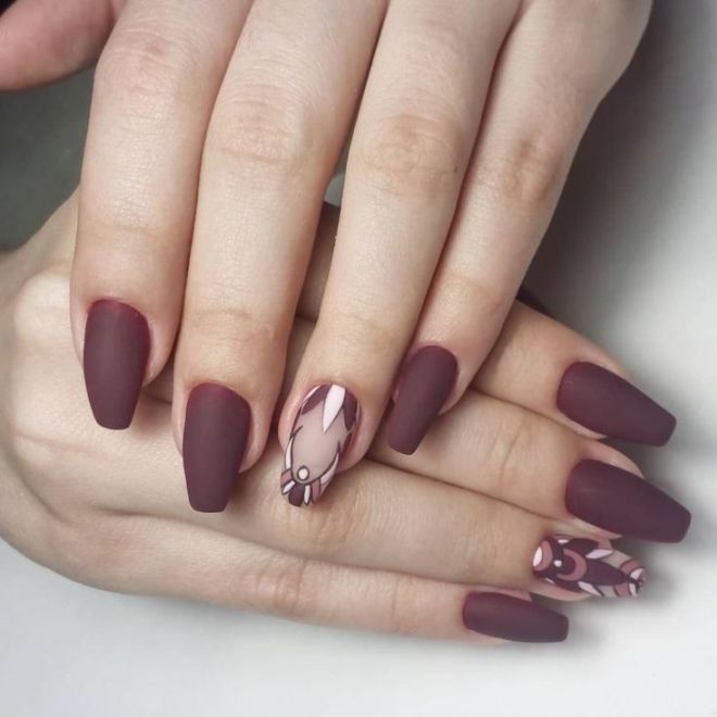 Matte burgundy manicure with a pattern of times